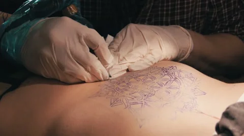 Tattoo master making a tattoo of mandala pattern. Close up shot of hands Stock Footage 67515656