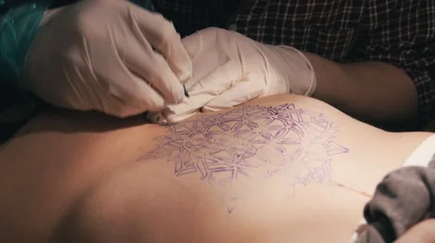 Tattoo master making a tattoo of mandala pattern. Close up shot of hands Stock Footage 67516161