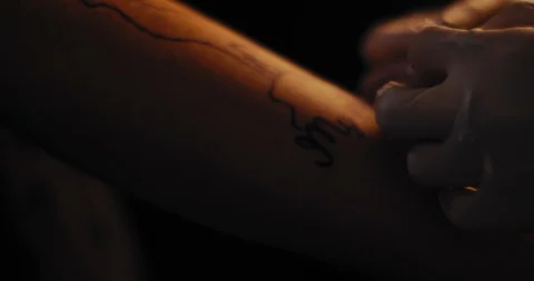 Tattoo master putting a drawing on a person's hand before making a tattoo. Stock Footage 125764741
