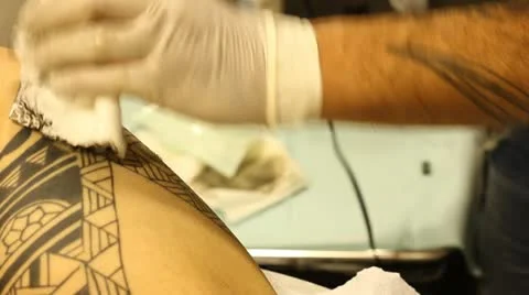 Tattoo shop tattooing pain artists body art skin needle draw sterile hiv pain Stock Footage