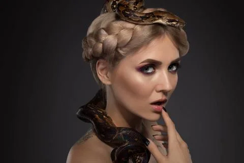 Tattooed blonde with python on black background Beautiful tattooed blonde ... Foto stock