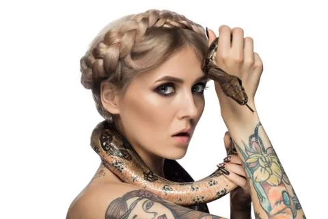 Tattooed blonde with python on white background Photos