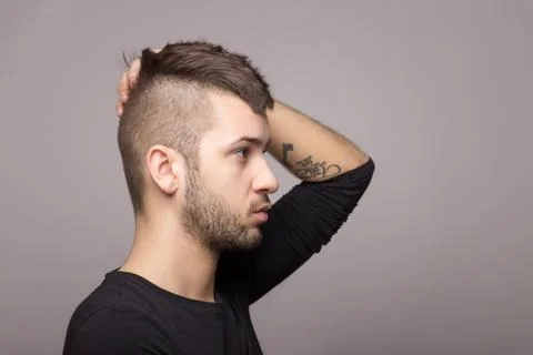 Tattooed boy with mohawk. Stock Photos