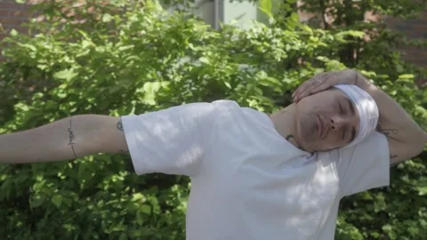 A tattooed dancer wearing is doing warm-up stretches, getting ready for a dance. Stock Footage 283489891