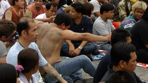 A tattooed devotee at Wat Bang Phra enters a powerful trance. Stock Footage 121084633
