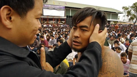 A tattooed devotee at Wat Bang Phra is released from his trance. Stock Footage 121087666