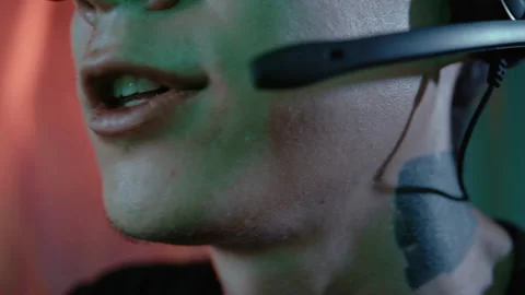 Tattooed hacker talking into headset microphone Stock Footage 341662073