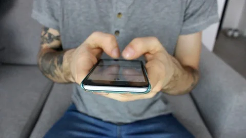 Tattooed hipster guys using a phone Stock Footage 86572291