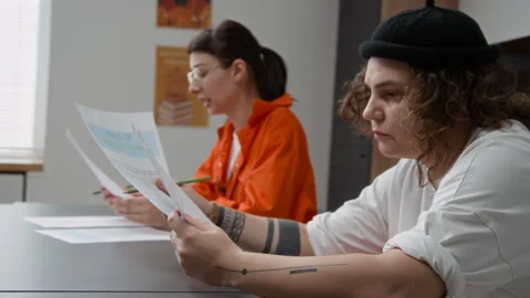 Tattooed Inmate Attending Class in Prison and Reading Tasks Stock Footage 328986320
