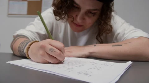 Tattooed Inmate Doing Tests and Attending Class in Prison Stock Footage 328997857