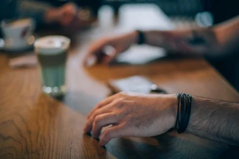 Tattooed male hands gesticulating while talking Stock Photos