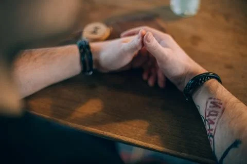 Tattooed male hands gesticulating while talking Stock Photos