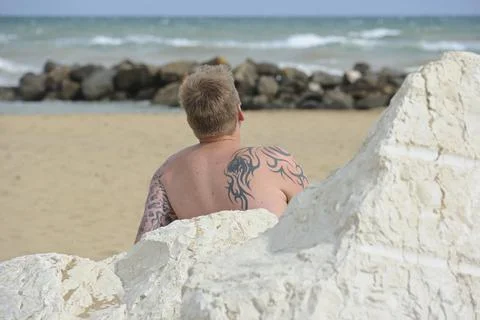 Tattooed man on the beach Stock Photos