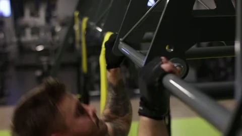 Tattooed man doing pull ups in the gym Stock Footage 83129275