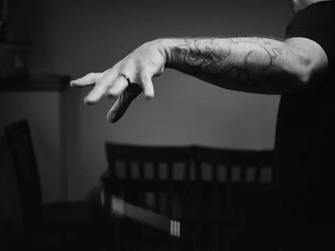 Tattooed Man with Mic Drop Stock Photos