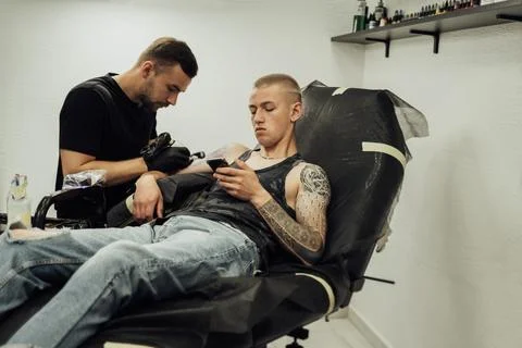 Tattooed Man on the Process of Creating New Tattoo at Studio, Male Artist Draws Stock Photos