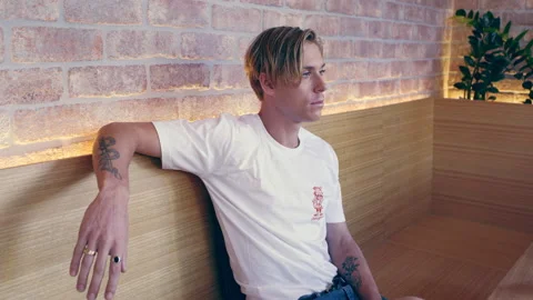 Tattooed millennial man sitting inside coffee shop in Australia during the day. Stock Footage 199456054