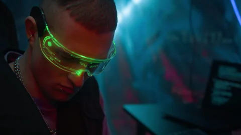 Tattooed Programmer in Neon Visor Coding in Cyberpunk Workspace Stock Footage 327636184