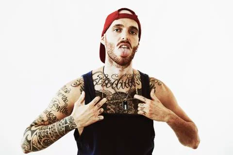 Tattooed rap singer posing in studio on a white background Stock Photos