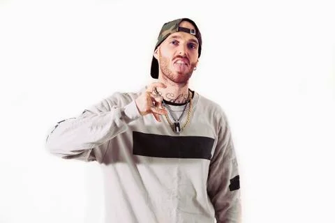Tattooed rap singer posing in studio on a white background Stock Photos