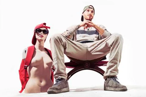 Tattooed rap singer posing in studio with a female dummy Stock Photos