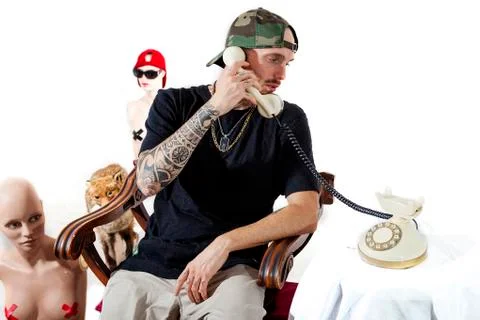Tattooed rap singer posing in studio with a female dummy Stock Photos