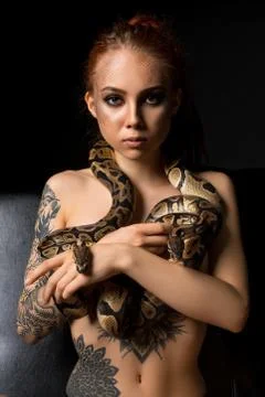 Tattooed woman with python view 写真素材