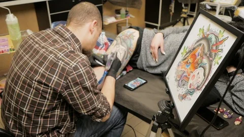 Tattooer at work in studio Stock Footage 88377644