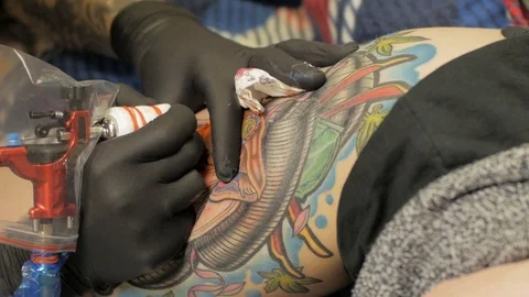 Tattooer at work in studio Stock Footage 88377846