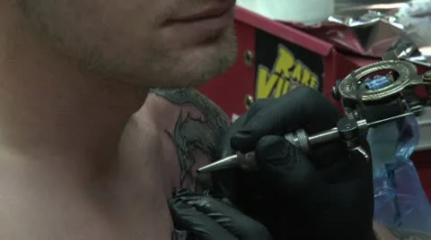 Tattooing dragon upper left shoulder medium shot Video stock 10604930