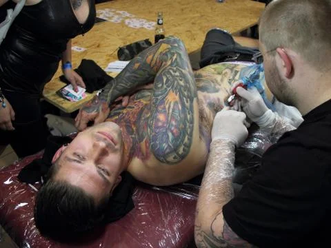 Tattooing a man Stock Photos