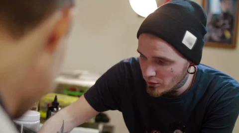 Tattooist advises the client at the studio Stock Footage 62422197