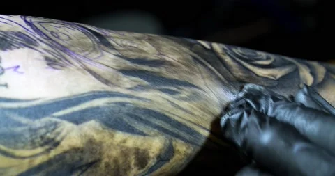 Tattooist draws a pattern on clients arm Stock Footage 139707865