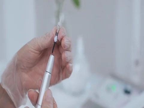 Tattooist is preparing gun tool for procedure permanent makeup Stock Footage 74412580