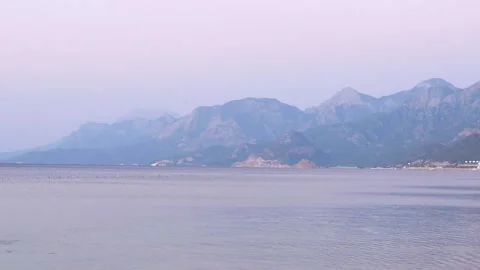 Taurus mountains on the horizon in the evening. View from Konyaalti beach Turkey Video stock 229548116