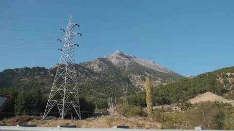 The Taurus range in Turkey seen from a car with electrical poles on the way Stock Footage 146029850