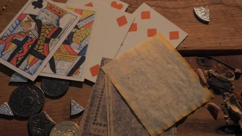 Tavern tabletop - playing cards, dice and gambling by candle light in saloon 動画素材 104565814