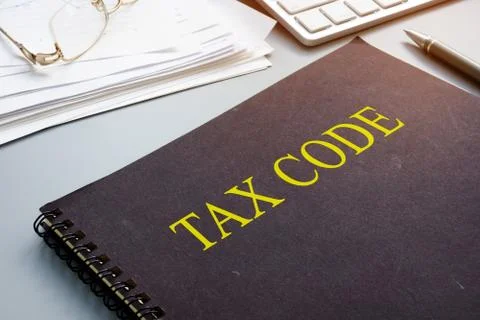 Tax code and financial documents in the office. Stock Photos
