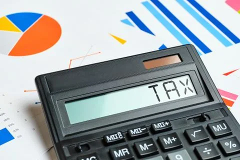 Tax concept on calculator and chart sheets Stock Photos
