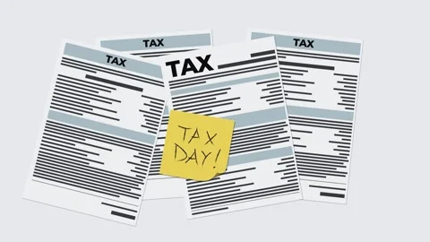 Tax day. Tax return forms accumulating on a gray background, isolated. Stock Footage 310650423