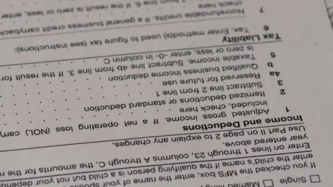 Tax forms 1040 for individuals us close up rotation , concept paying taxes .. Stock Footage 282792914