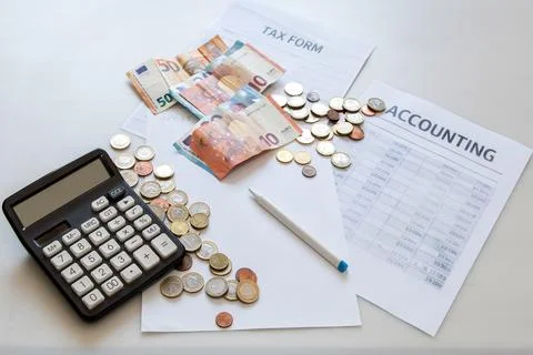 Tax forms and accounting documents with euro banknotes, coins, a planning Fotos Stock
