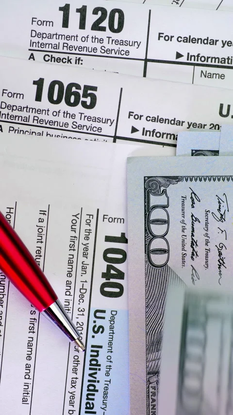 Tax forms, hundred dollar bills, and red pen for financial paperwork Stock Footage 344968900