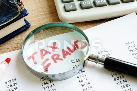Tax fraud written on the audit report. Stock Photos