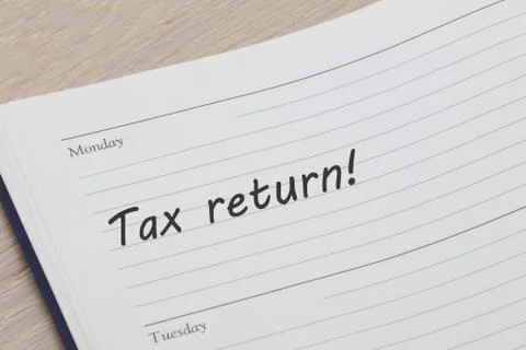 Tax return diary reminder open on desk Stock Photos