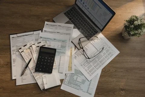 Tax return documents, calculator, receipts, and laptop with financial sprea.. Stock Photos