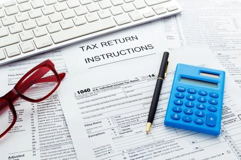 Tax return form with computer keyboard and calculator Stock Photos