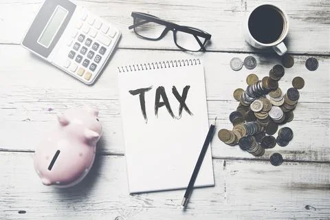 Tax text on notepad Stock Photos