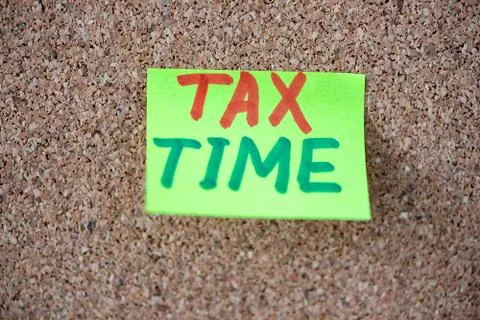 Tax Time concept on the sticky note paper. Stock Photos