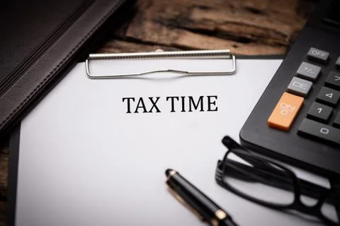 Tax Time text on Document and gavel isolated on wooden office desk Stock Photos